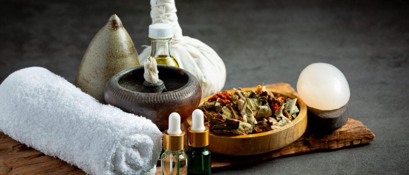 Herbal compress and herbal spa treatment equipments put on dark floor